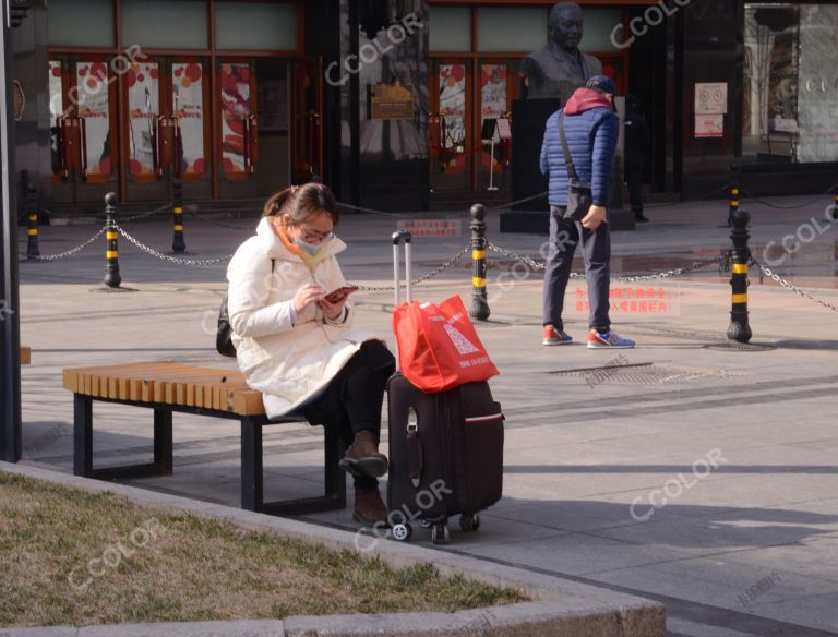 场景类：疫情防控期，王府井大街带行李箱的女青年